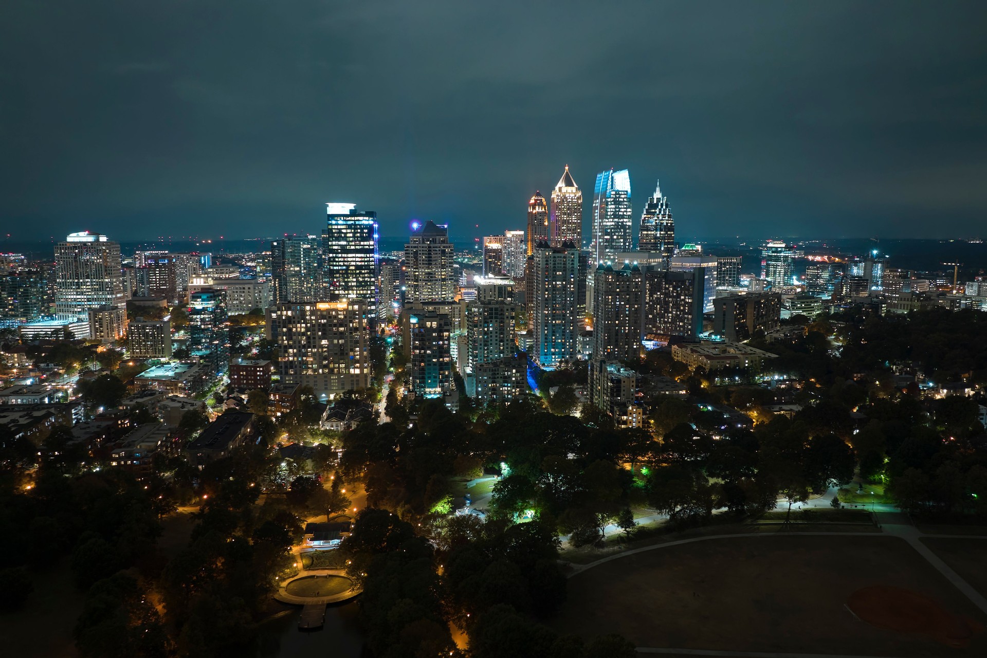 Aerial view of downtown district of Atlanta city in Georgia, USA. Brightly illuminated high skyscraper buildings in modern american midtown